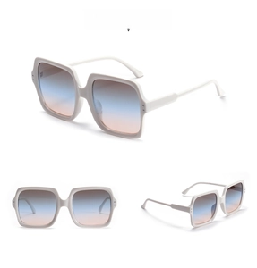 Macro detail of square beige sunglasses frame with gradient blue-pink lenses and metal accents