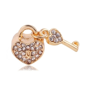 Golden heart lock and key charm pendant with white zircon stones on a white background