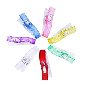 Radial arrangement of colorful heart-shaped plastic paper clips on white background