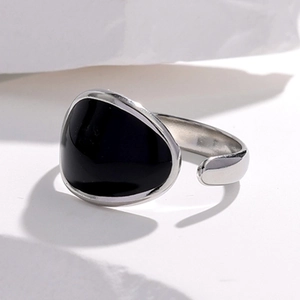 Detail shot of an adjustable silver ring with minimalist black enamel finish