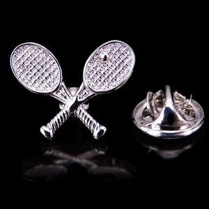 Detailed close-up of a silver tennis racket brooch featuring a secure butterfly clutch back