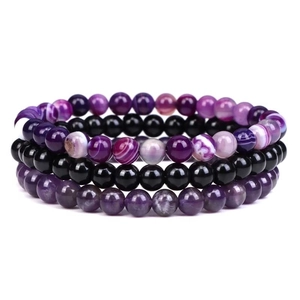 Detail of 3-piece beaded bracelet set featuring purple agate and black obsidian beads