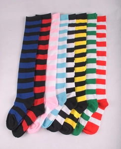 Flat lay display of colorful striped over-the-knee socks in various knit colorways