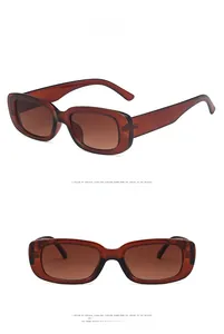 Close-up detail of brown rectangular sunglasses with thick frames and retro design