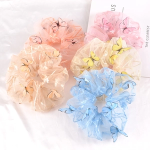 Detail of five-piece mesh hair scrunchies with 3D butterflies and gold silk texture