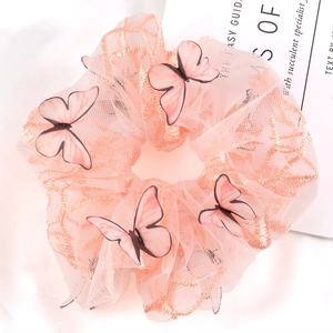Close-up of pink mesh scrunchie featuring detailed 3D butterfly embellishments