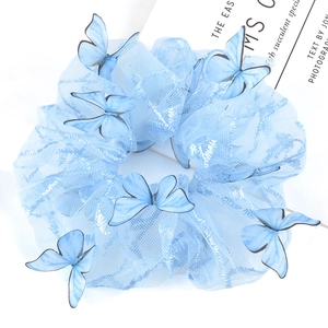 Close-up of sky blue mesh scrunchie featuring realistic 3D butterfly decorations