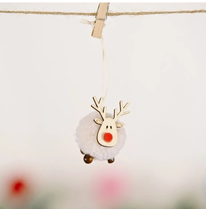 Detail of a felt Christmas reindeer ornament with wooden head and plush ball body