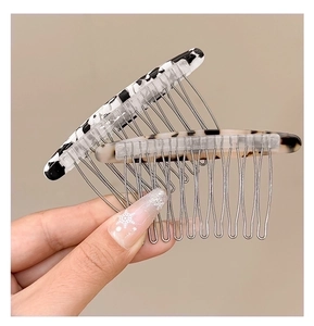 Dettaglio macro di pettini per capelli in acetato con motivi tartaruga e marmo
