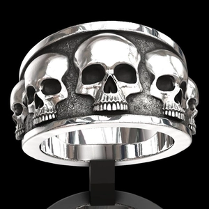 Detail of silver punk ring with relief skull engravings and vintage oxidized finish