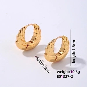 Macro detail of gold geometric hollow earrings with textured surface and size dimensions