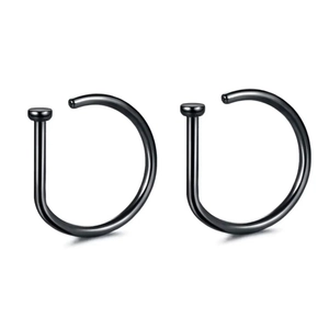 Close-up of two polished black D-shaped surgical steel nose rings on a white background