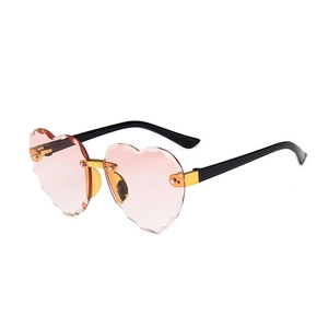 Rimless heart-shaped sunglasses with gradient pink lenses and gold metal accents