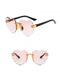 Detail view of heart-shaped rimless sunglasses for kids with pink gradient lenses