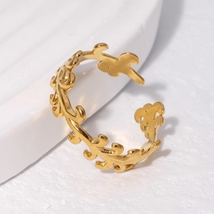 Macro detail of adjustable golden leaf ring showing intricate leaf texture and polished finish