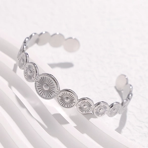 Retro geometric open silver bangle with embossed round sun patterns in stainless steel