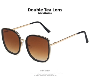 Detail view of large square frame sunglasses with gold temples and gradient brown lenses
