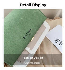 Close-up of green suede flap with gold lock on cream faux leather crossbody bag