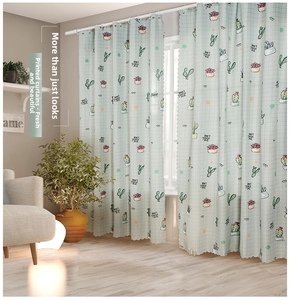 Detail of mint green plaid curtain with cactus print and scalloped edges in a bright room