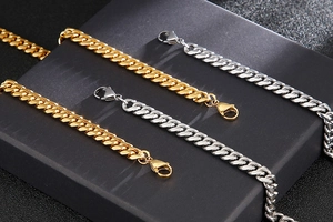 Parallel layout of 8mm gold and silver polished Cuban link chains with lobster clasps