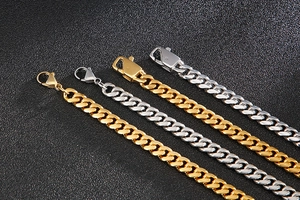 Detailed view of 8mm gold and silver polished stainless steel Cuban chains with sleek clasps