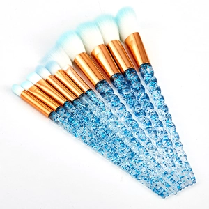 10-piece makeup brush set with blue gradient bristles and transparent glitter handles
