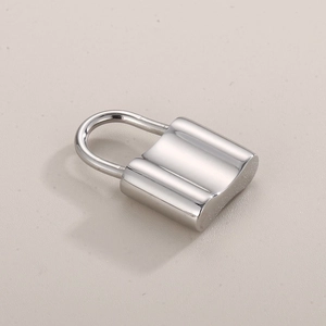 Polished silver stainless steel padlock pendant for DIY jewelry on a beige surface