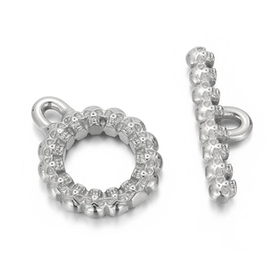 Macro detail of silver skull engraved toggle clasp and T-bar for jewelry making