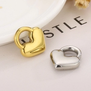 Close-up of gold and silver heart-shaped lock pendants with polished finish for DIY jewelry