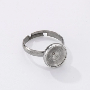 Close-up of adjustable silver stainless steel ring base with circular blank tray for DIY