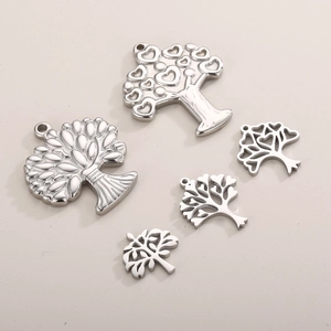 Detailed view of five unique silver stainless steel tree of life charms for jewelry DIY