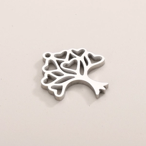 Macro detail of silver Tree of Life pendant featuring intricate heart-shaped cutouts