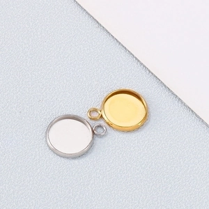 Detailed view of round gold and silver stainless steel jewelry pendant tray bases