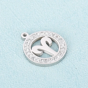 Macro view of silver Aries zodiac pendant with crystal stones and metal finish