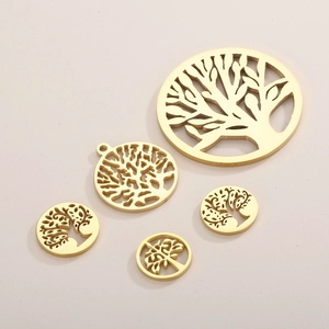 Set of five gold Tree of Life stainless steel pendants in assorted sizes on beige background