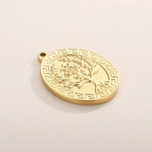 Macro shot of gold tree of life pendant with Greek meander border pattern engraving