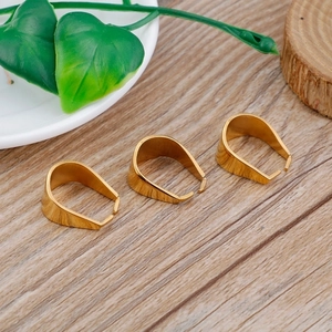 Detailed view of three golden stainless steel bail clasps for DIY jewelry making