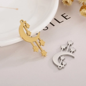 Detailed macro view of moon and star tassels for jewelry making in gold and silver finish