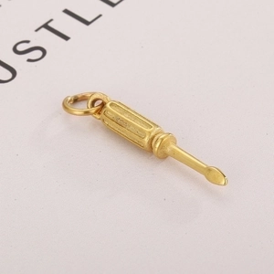 Close-up of a creative gold screwdriver pendant with detailed anti-slip handle textures
