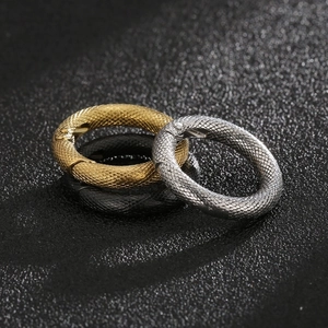 Macro shot of stainless steel spring clasps with snake skin texture in gold, silver and black