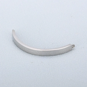 Close-up of polished silver curved metal connector with ring for jewelry making