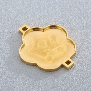 Detailed view of flower-shaped gold plated stainless steel pendant connector with dual loops