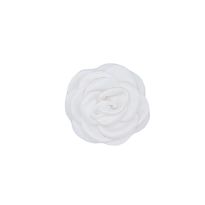 Detail view of handmade white satin camellia flower for hair and garment accessories