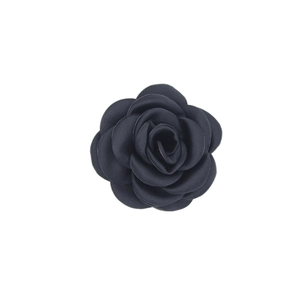 Detailed view of handmade black satin camellia flower accessory with silk sheen