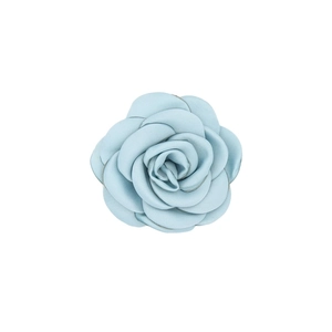 Macro shot of light blue satin handmade camellia flower accessory for hair or clothing