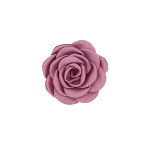Detail of a dusty rose satin camellia flower for hair accessories and garment decor