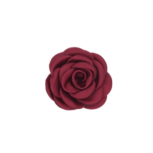 Close-up of handmade burgundy satin camellia flower for garments and hair accessories