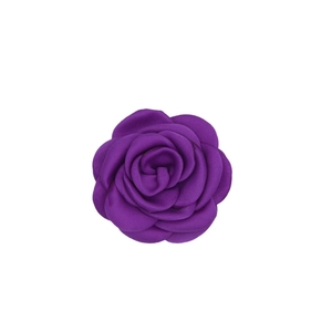 Macro shot of purple satin fabric camellia flower with handcrafted burnt edges