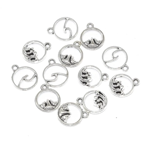 Set of antique silver hollow round pendants with mountain and sea wave patterns