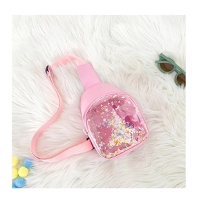 Detail of light pink crossbody bag with colorful sequins inside a clear PVC window pocket